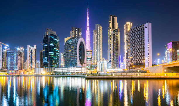 Alt text: "Night view of city skyscrapers and waterfront, representing RAKEZ Free Zone's business potential."